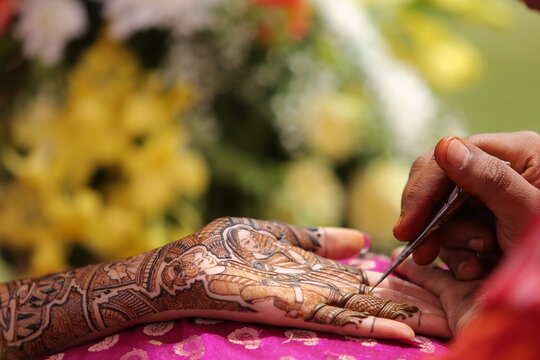 Mumbai, India 13th September 2022: Close-up shots of an Indian bride getting henna also known as Mehendi or mehndi done. Henna pattern. Traditional Rasam or rivaz of done with henna mehandi