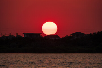 The sun goes down over a lake