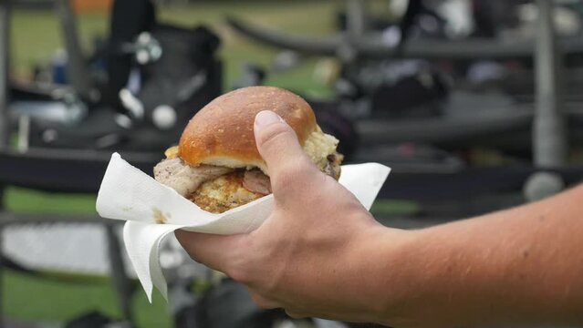 Close up on a burger being carried during an event