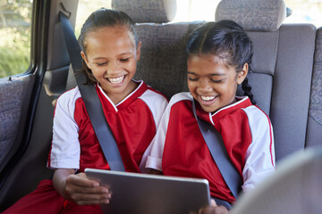 Children, happy and tablet in car smile, browse online and use social media apps or funny video....
