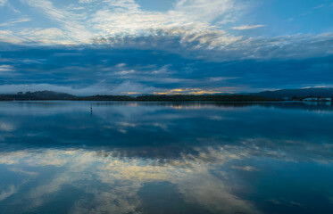 Fototapeta premium Respite from the rain - Bay waterscape with reflections