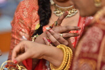 Fototapeta na wymiar Mumbai, India 14th September 2022: Indian Wedding rituals, Customs and Traditions for bride or Dulhan. Pandit performing holy pooja. Shagun, Mehendi, and old customs. Poojan vidhi and samagri.