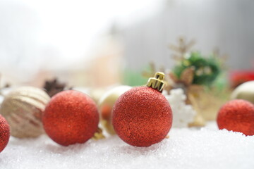 Fototapeta na wymiar Christmas decoration. Christmas spruce with ball and blurred shiny lights. Christmas composition is with colorful balls on snow. Christmas decoration on snow with blur abstract background