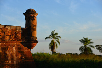 Sunset on a watchtower on the walls of the Real Forte Príncipe da Beira fort ruins , near the town of Costa Marques, Rondonia state, Brazil, on the border with the Beni Department, Bolivia - obrazy, fototapety, plakaty