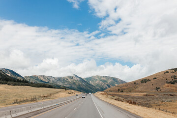 Highway among beautiful mountains. Beautiful road landscape with mountains and high sky with clouds. Echo Canyon, Utah 84017, USA - 08.02.2022