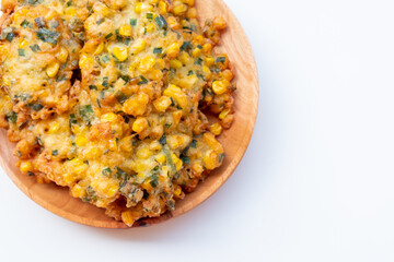 Indonesian Corn Fritters on wooden plate with white background