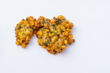 Indonesian Corn Fritters on wooden plate with white background