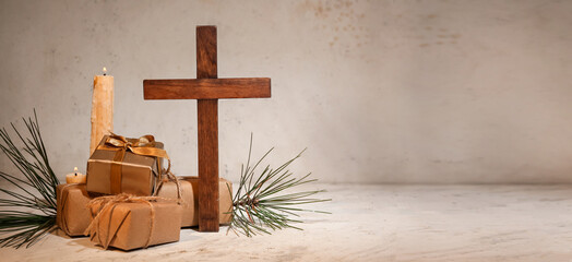 Cross, candle and gifts on light background with space for text. Concept of Christmas story
