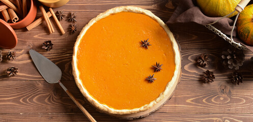 Tasty pumpkin pie on wooden table. Thanksgiving Day celebration