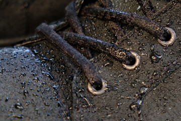 close-up details waterproof men's black boots. Drops of rain on suede shoes.