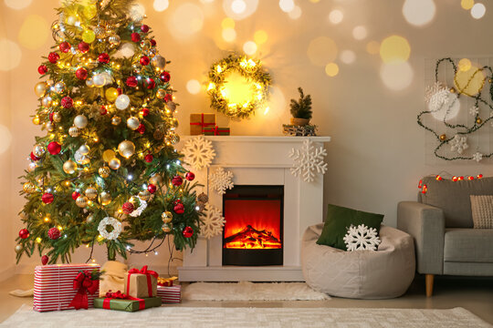 Interior of modern living room with beautiful Christmas tree, gifts and fireplace