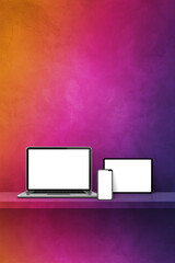 Laptop, mobile phone and digital tablet pc on rainbow wall shelf. Vertical background