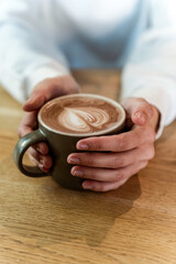 Woman ready to drink hot chocolate. Female hand holding cup with warm hot drink