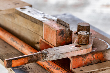 Manual machine for bending reinforcement. Close-up. Reinforcement bending in construction conditions. Mechanism for bending steel rods.