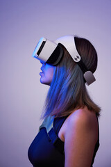 Woman is using virtual reality headset. Concept of virtual, augmented and extended reality and...