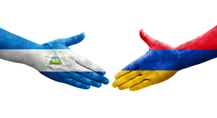 Handshake between Armenia and Nicaragua flags painted on hands, isolated transparent image.