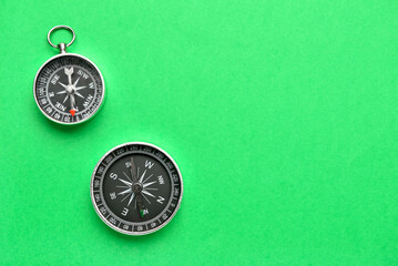 Old compasses on green background