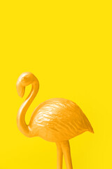 Golden flamingo on yellow background