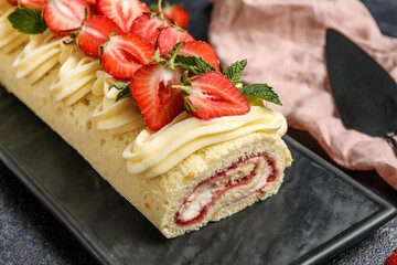 Board with tasty strawberry roll cake, closeup