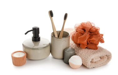 Set of different bath supplies with candles on white background