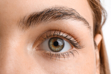 Young woman with beautiful hazel eyes on white background, closeup