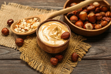Bowl of tasty hazelnut butter on wooden table