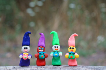 Figurines of colorful fairy-tale dwarfs with gifts. Decorations for the holiday, birthday.