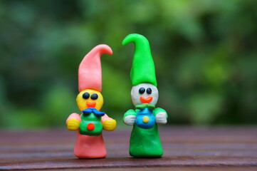 Figurines of colorful fairy-tale dwarfs with gifts. Decorations for the holiday, birthday.