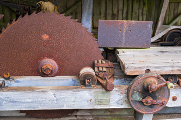 Old rusty circular saw in a sawmill - obrazy, fototapety, plakaty