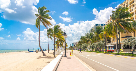 Seafront beach promenade with palm trees on a sunny day in Fort Lauderdale - obrazy, fototapety, plakaty