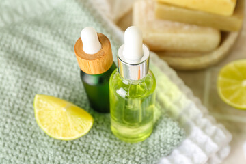 Glass bottles with citrus serum on table