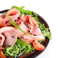 Plate with sliced ham isolated on white background, closeup