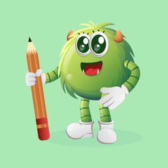 Cute green monster holding pencil