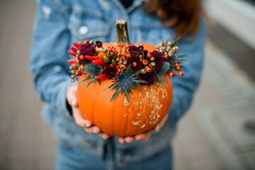 wonderful orange pumpkin with thistle, red pepper, berries and chrysanthemums. Decor for thanksgiving and halloween. © fesenko