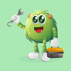 Cute green monster holding spanner and tolls box