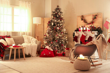 Interior of living room with Christmas tree, sofa and armchair