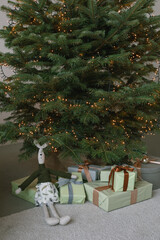 Christmas tree with wrapped gifts. Minimalistic holiday decor. 