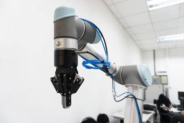 robotic arm catch for electronic assembly line. The robot for smart technology manufacturing process.