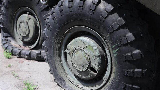 Shot through the wheels of an armored personnel carrier during the war. Military equipment, close-up. Military conflict and war.