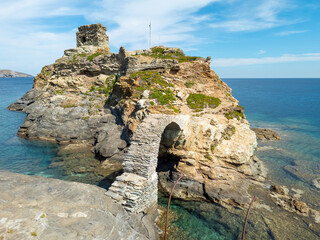 Venetian ancient Lower Castle at Andros island Chora, Cyclades Greece. Arched stone bridge over sea