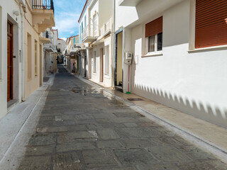 Andros island destination Cyclades Greece. Chora town traditional house souvenir shop paved alley