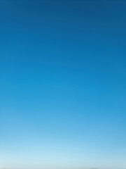 Sky blue background, texture. Bright horizon, summer day at Greek island Cyclades Greece. Vertical