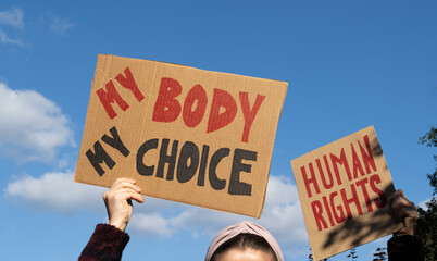 Protesters holding signs with slogans My Body My Choice and Human rights. People with placards...