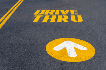 Yellow inscription Drive true and straight arrow on the asphalt