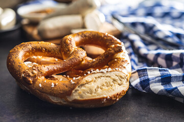 Baked bavarian pretzels on black table.