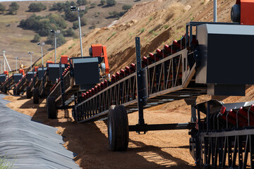 Empty conveyor belt sits  at a mining area.