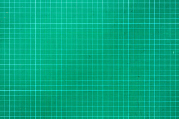 Plastic green cutting mat texture. squared sheet texture green background