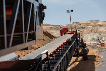 Empty conveyor belt sits  at a mining area.
