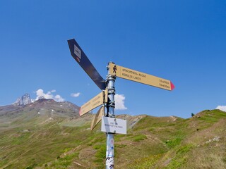 Signpost indicating way to Koruldi lakes, beautiful view of Great Caucasus mountains close to Mestia in Upper Svaneti, Georgia.