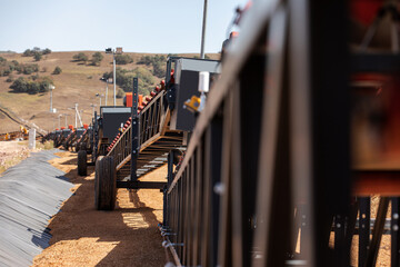 Empty conveyor belt sits  at a mining area.